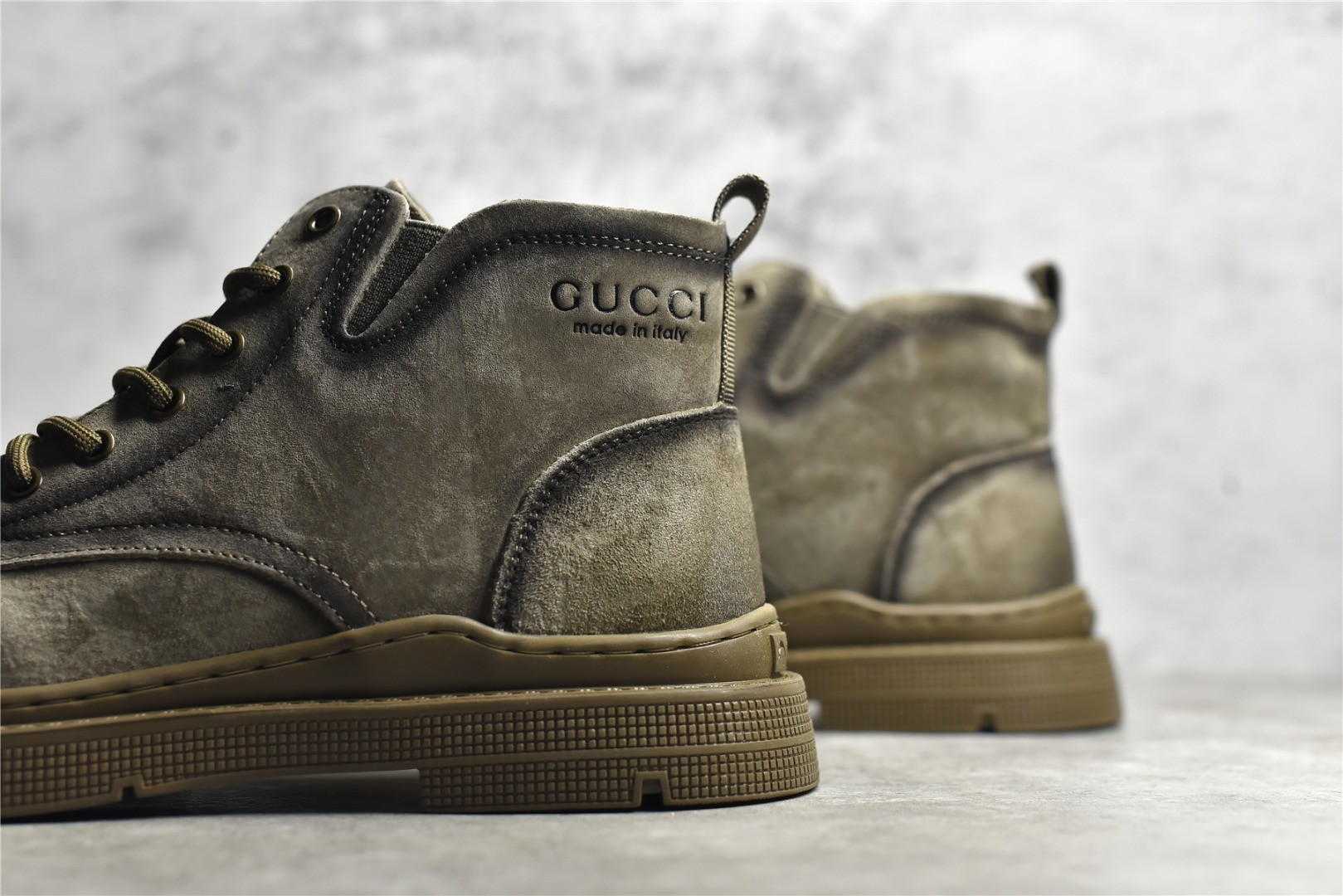 Gucci mid-top work boots/Doc Martens with a vintage distressed finish.