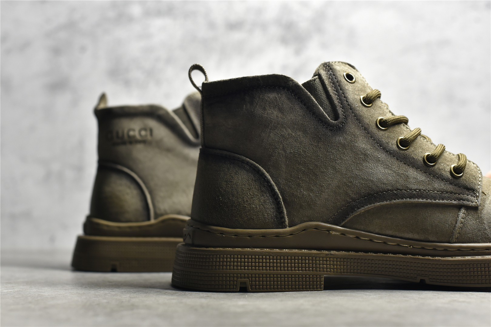 Gucci mid-top work boots/Doc Martens with a vintage distressed finish.