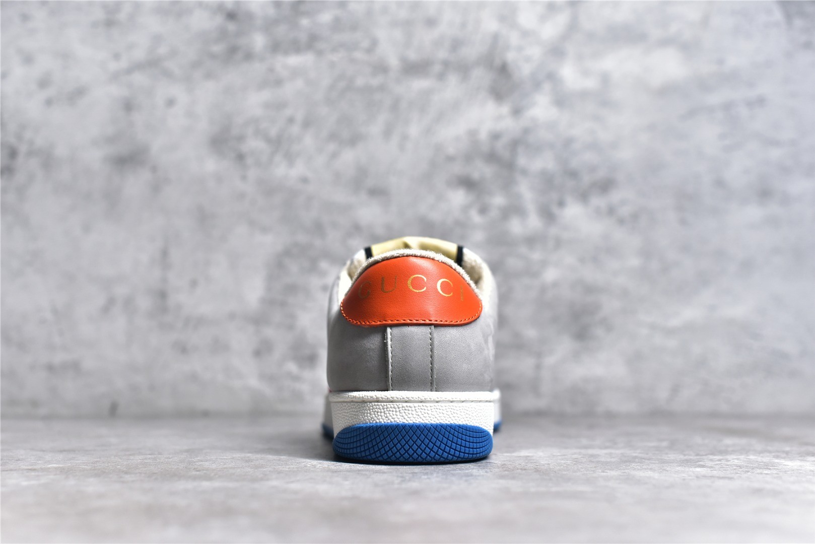Gucci Screener series distressed sneakers, grey, blue, and orange colorway.