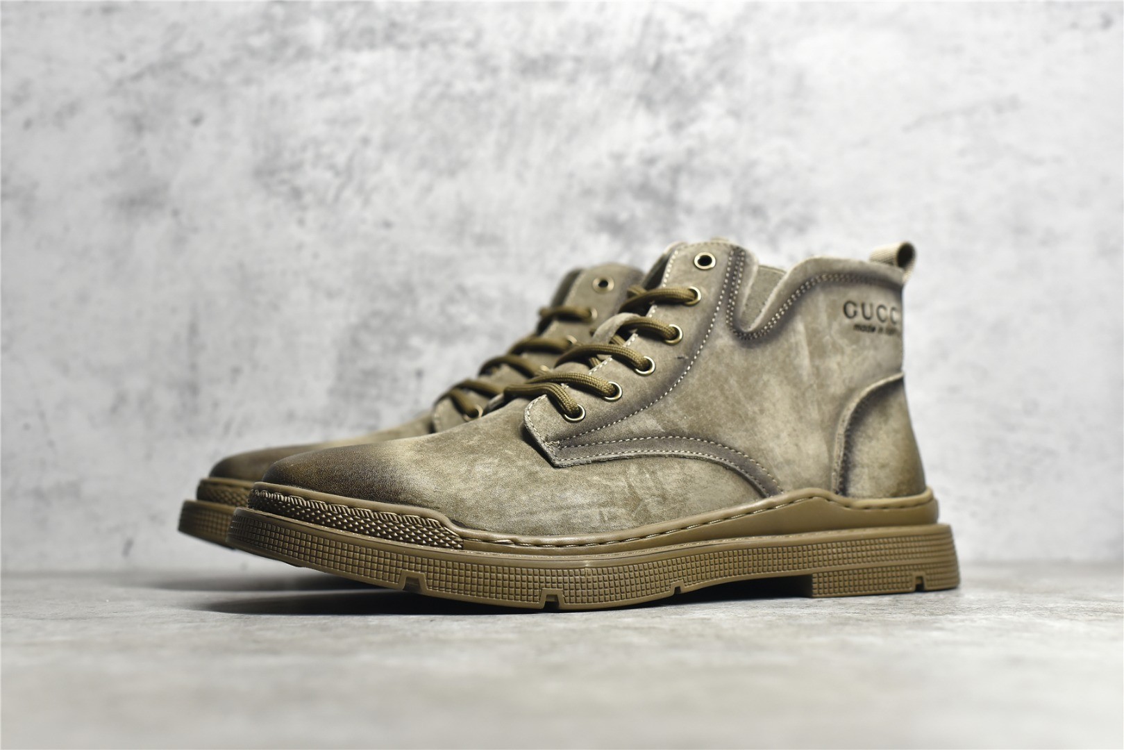 Gucci mid-top work boots/Doc Martens with a vintage distressed finish.