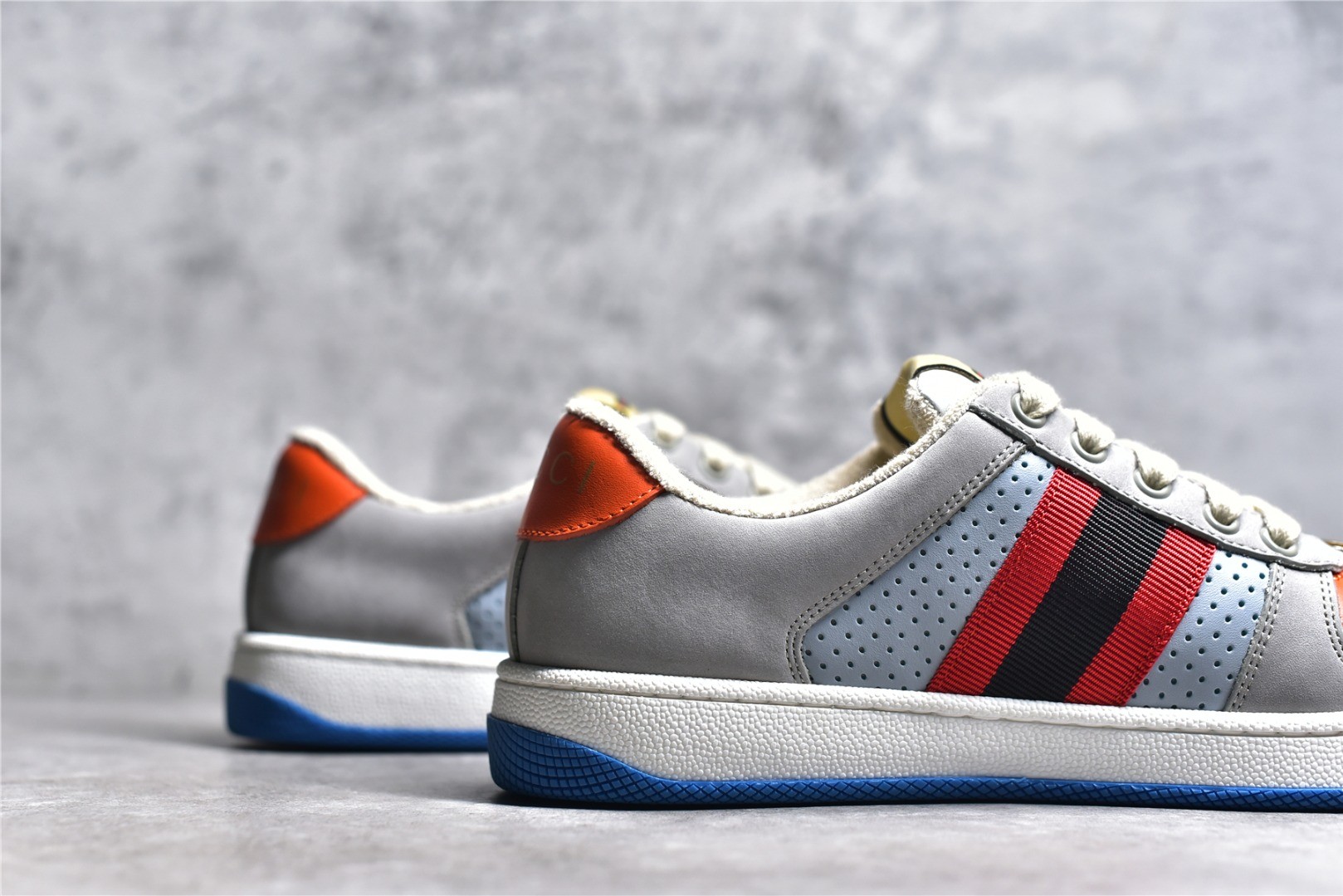 Gucci Screener series distressed sneakers, grey, blue, and orange colorway.
