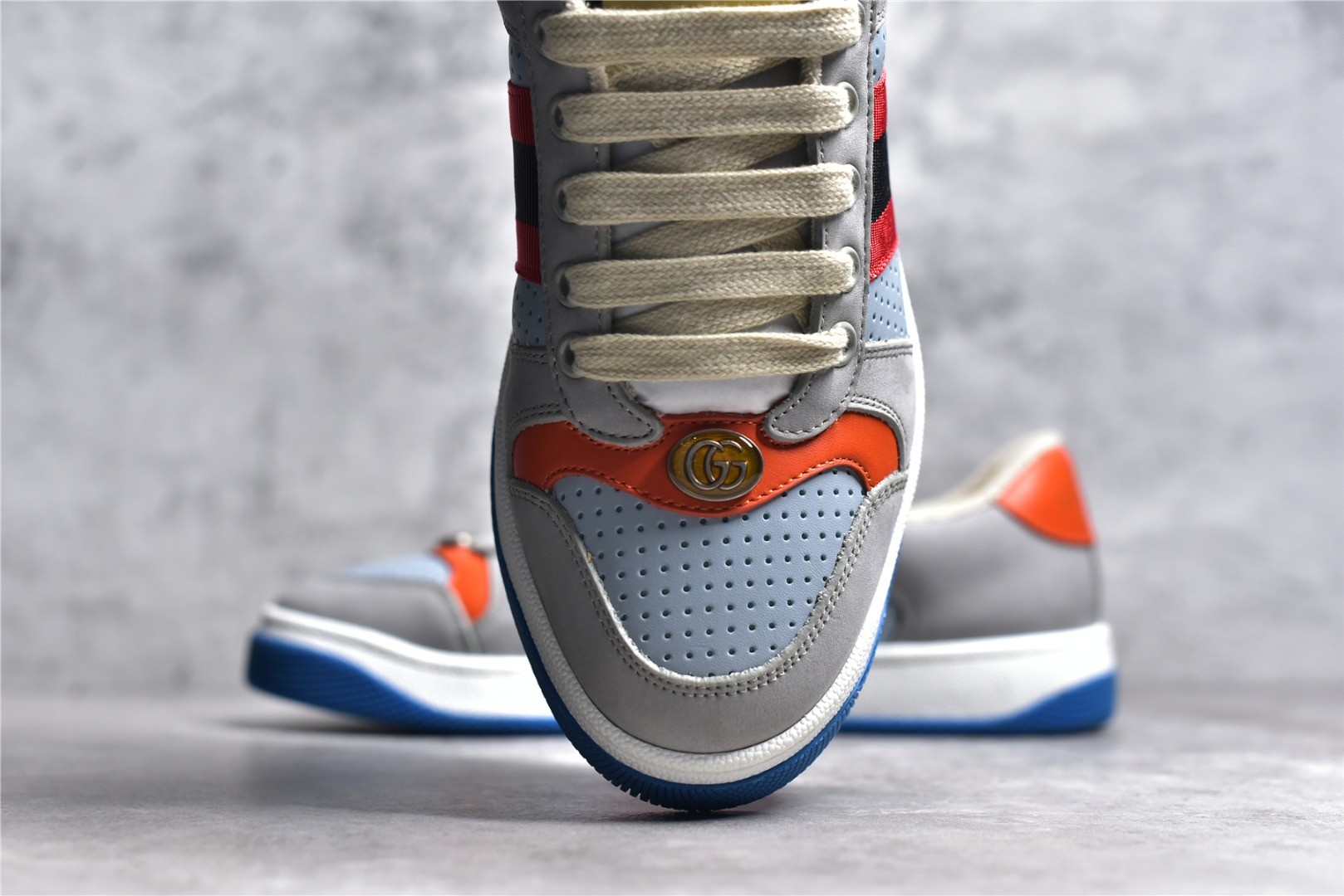 Gucci Screener series distressed sneakers, grey, blue, and orange colorway.