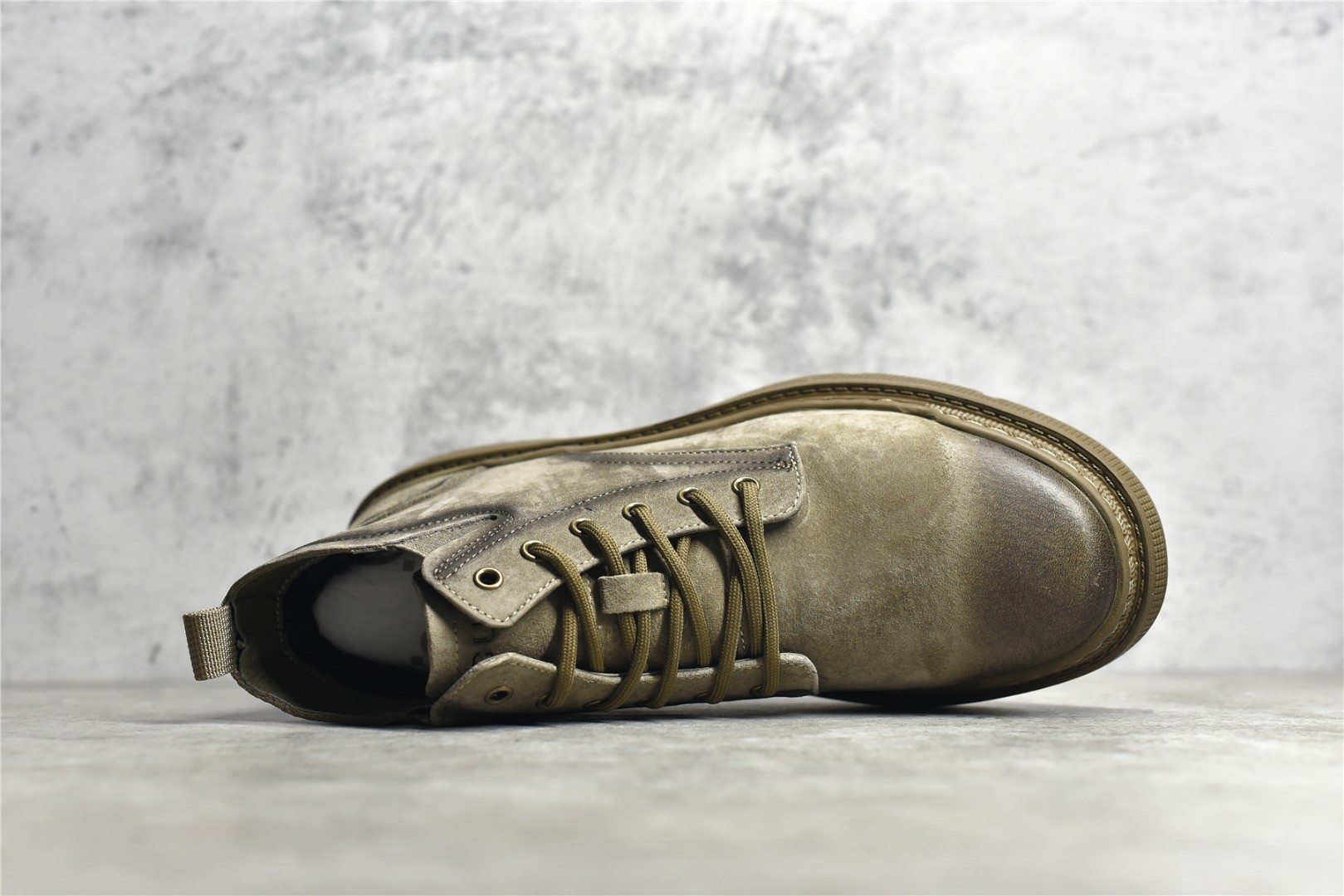 Gucci mid-top work boots/Doc Martens with a vintage distressed finish.