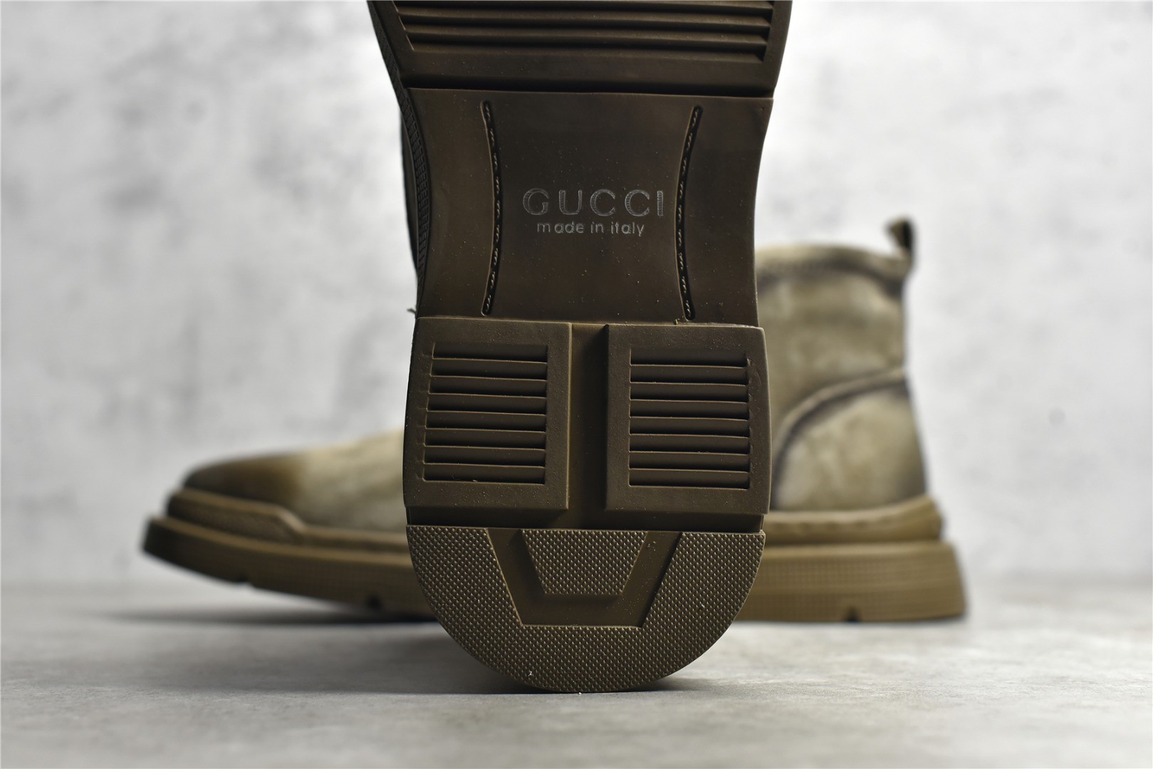 Gucci mid-top work boots/Doc Martens with a vintage distressed finish.