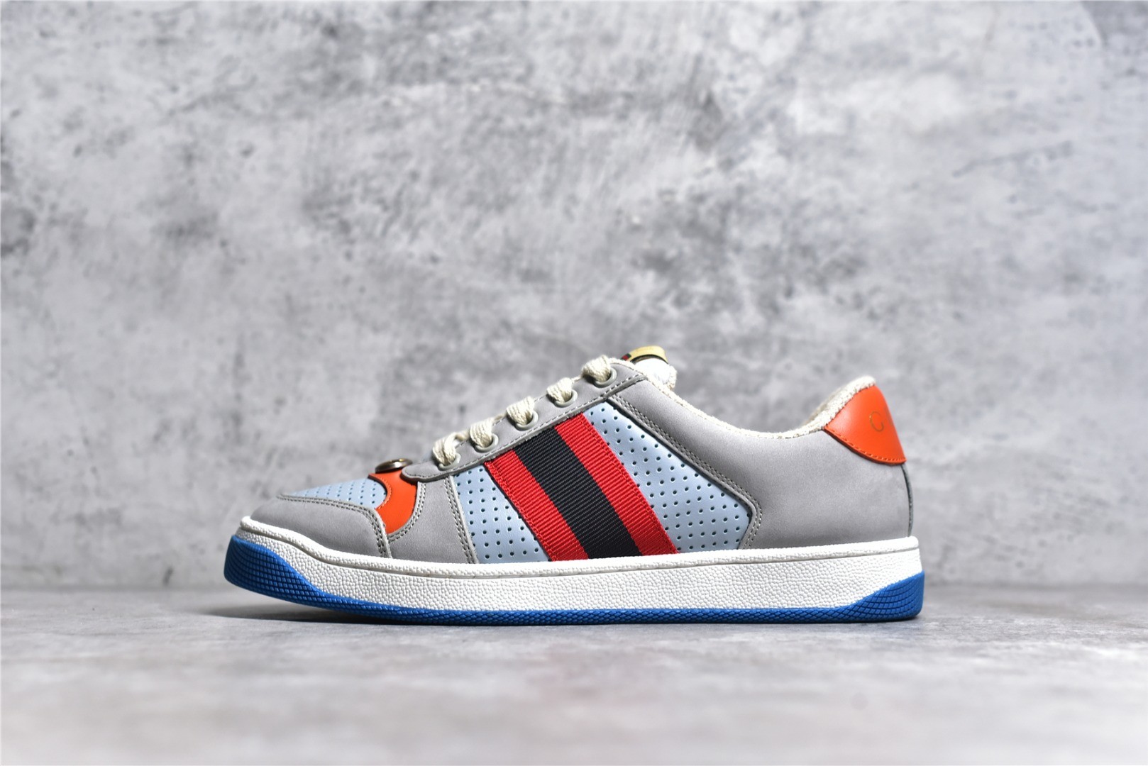 Gucci Screener series distressed sneakers, grey, blue, and orange colorway.