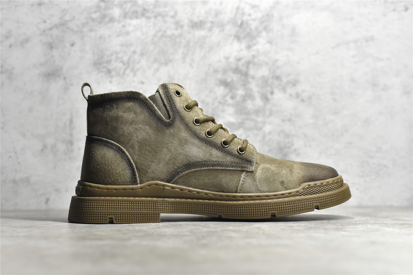 Gucci mid-top work boots/Doc Martens with a vintage distressed finish.