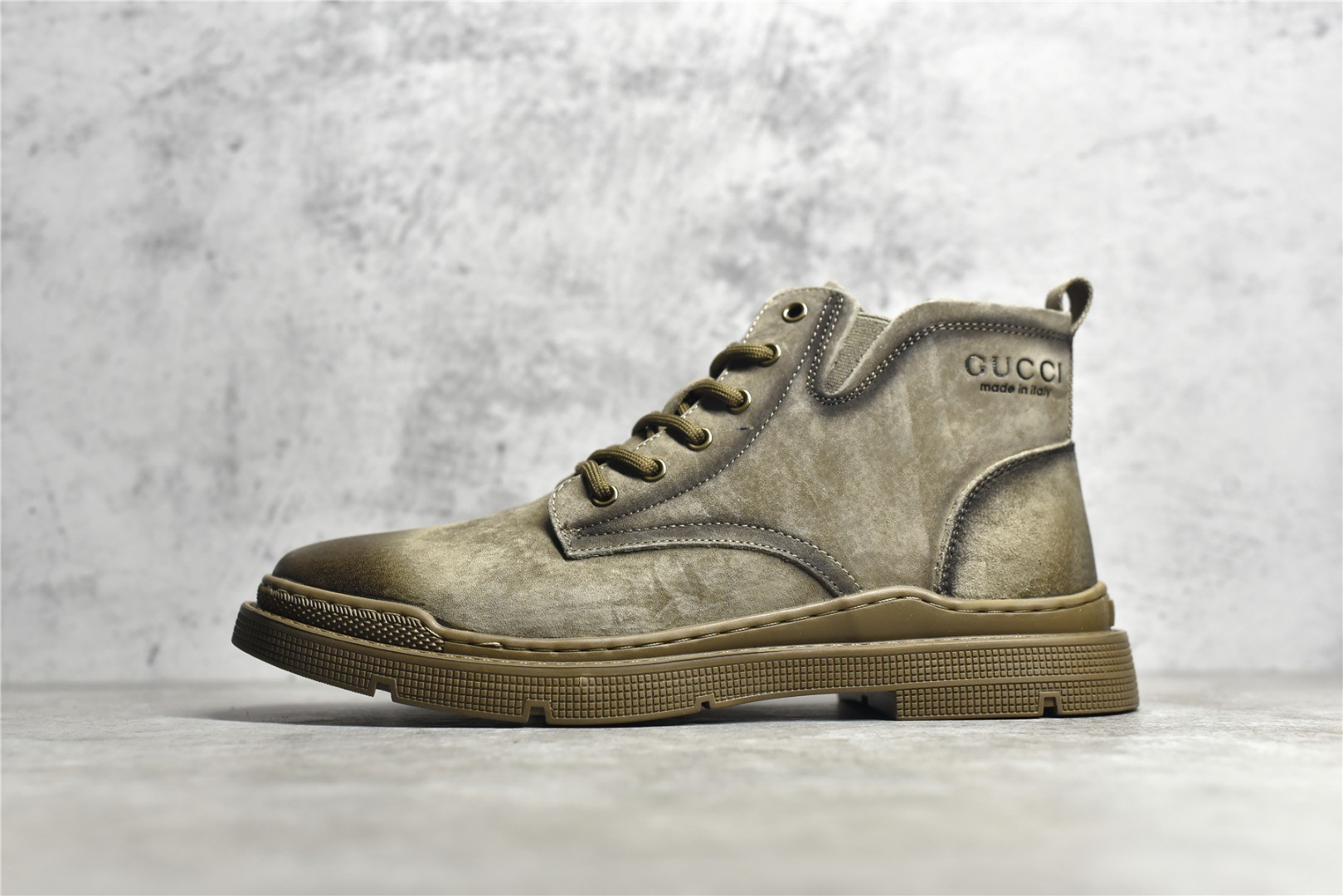 Gucci mid-top work boots/Doc Martens with a vintage distressed finish.