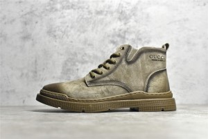 Gucci mid-top work boots/Doc Martens with a vintage distressed finish.